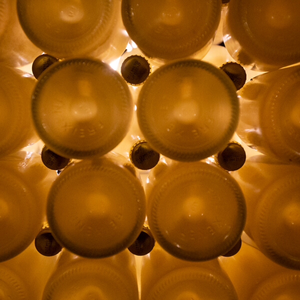 Wine bottles from below, showing sediment.