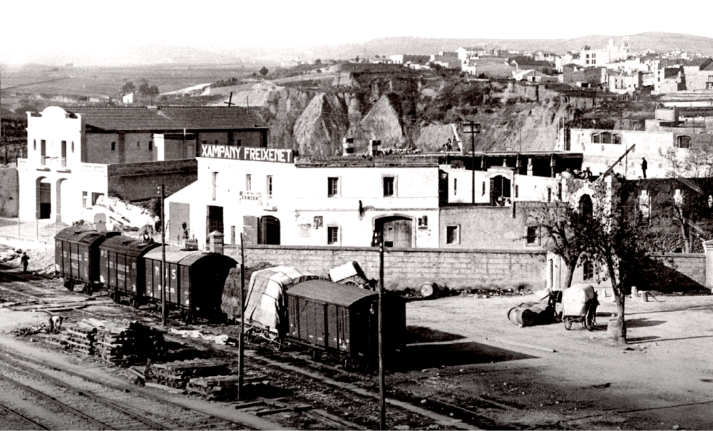 Freixenet’s expanded cellar, a white colonial-style building with a railroad in front.